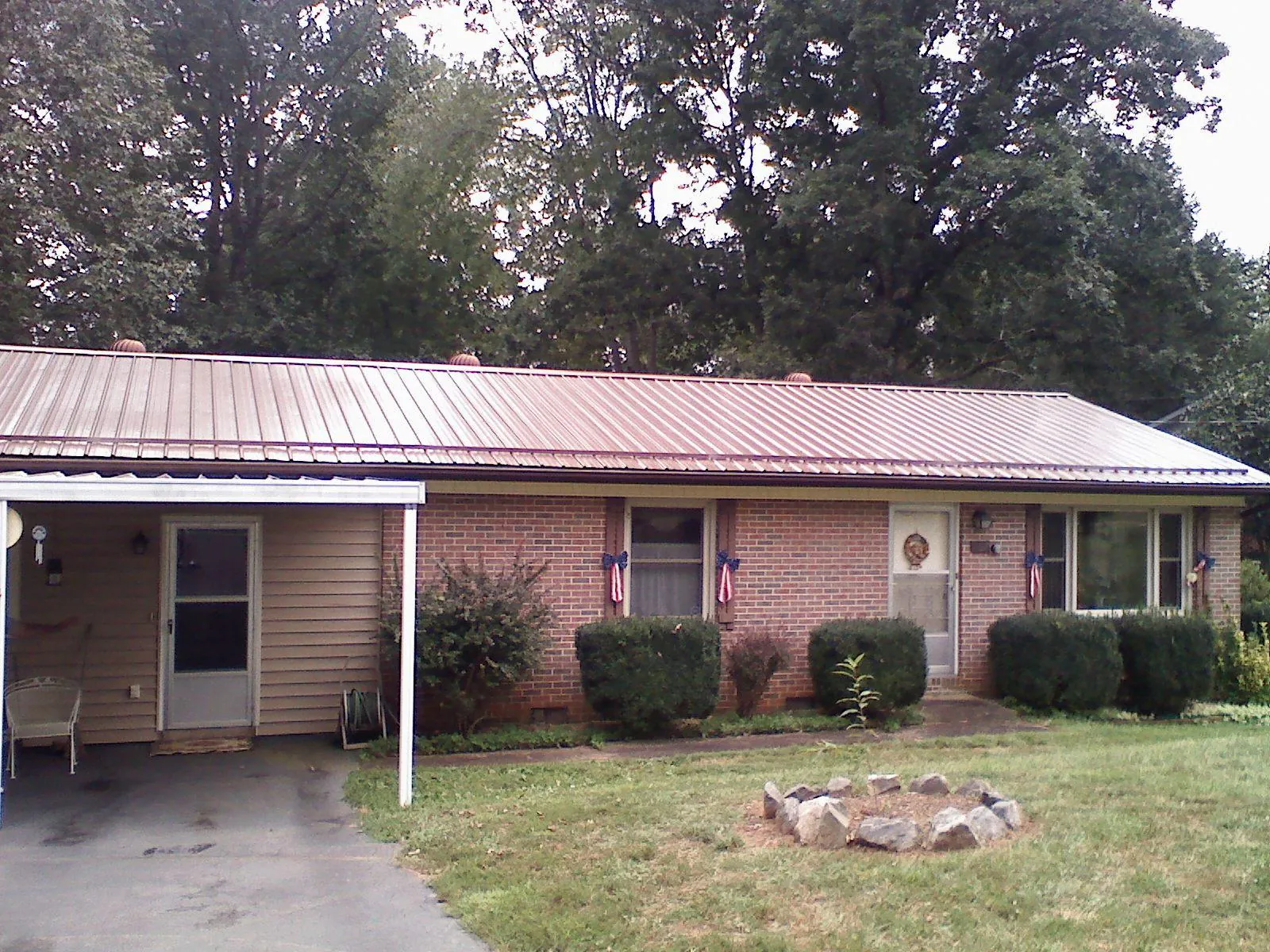 Bronze metal roof and carport on a brick ranch home — Roof Repair work by our crew in West Greenwich